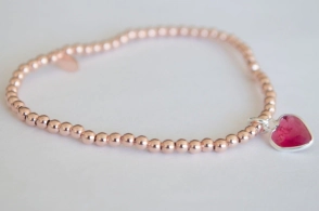 PU034 Pulsera PLATA ROSÉ elastizada bolas 3mm con corazón - 