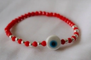L-PU0227 Pulsera cristal centro ceramica ojo ROJO