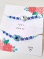AMI0036 Setx2 pulseras hilo chino celeste CORAZON cer�mica azul y celeste bolitas azul 
