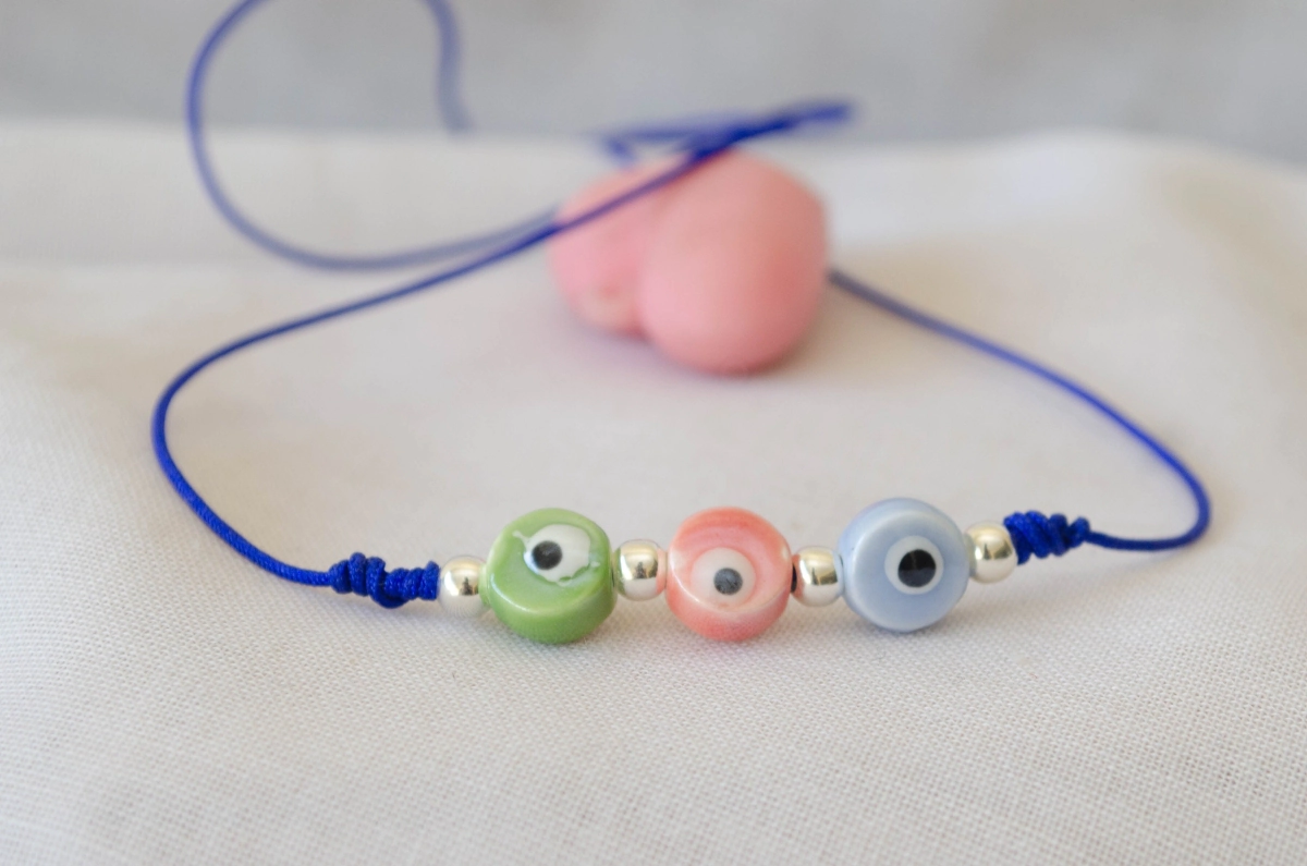 L-PU0237 Pulsera hilo azul 3 ojos ceramica