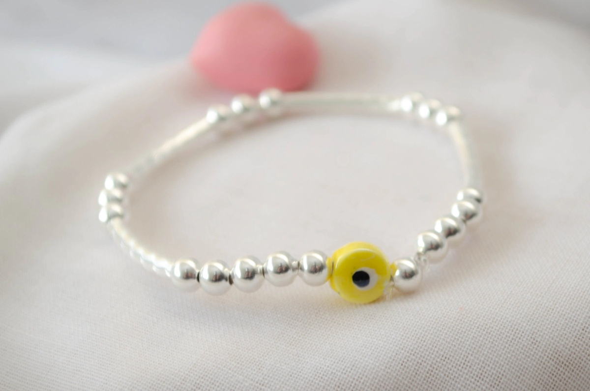 L-PU0238 Pulsera elastizada tubos bolitas ojo AMARILLO
