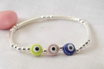 L-PU0241 Pulsera bolitas tubos elastizada centro OJOS CERAMICA COLORES