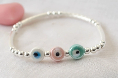 L-PU0241 Pulsera bolitas tubos elastizada centro OJOS CERAMICA COLORES